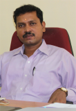 Kanagaraj M. Selvan sitting at his desk